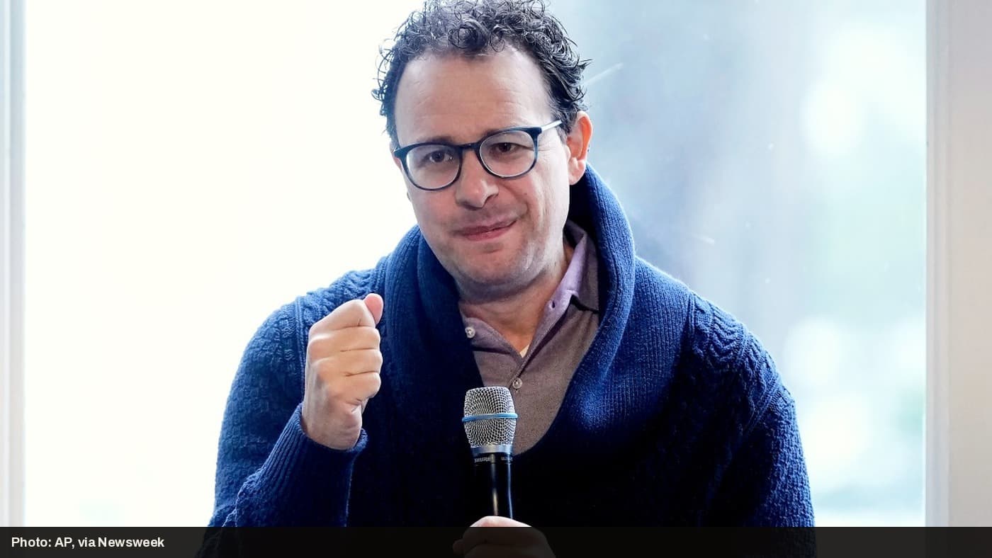 Anthropic CEO Dario Amodei speaking into a microphone.