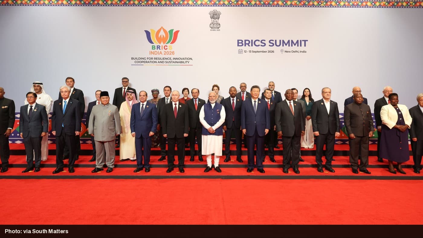 World leaders including Modi, Putin, and Xi Jinping pose for the official family photo at the 2026 BRICS Summit in New Delhi.