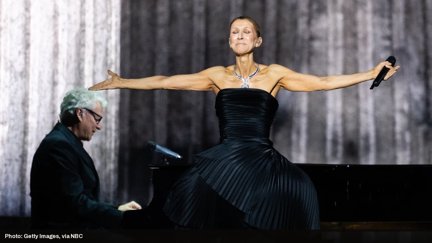 Celine Dion performs with arms outstretched on stage during her Paris residency opening night.