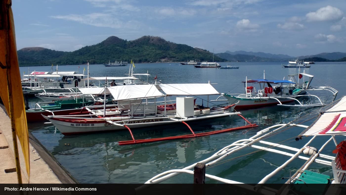 Boats docked at a pier in Coron, Palawan, Philippines.