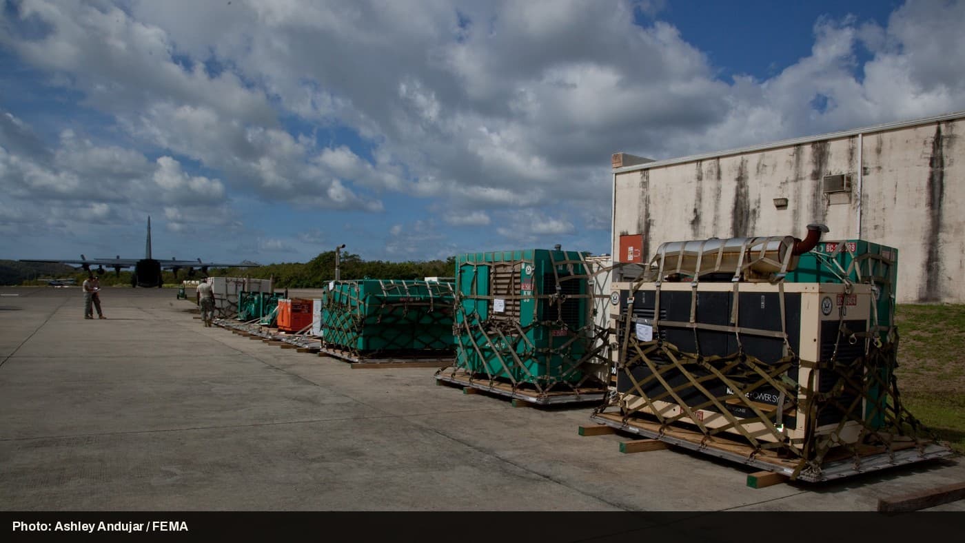 Industrial standby generators being loaded for shipment.