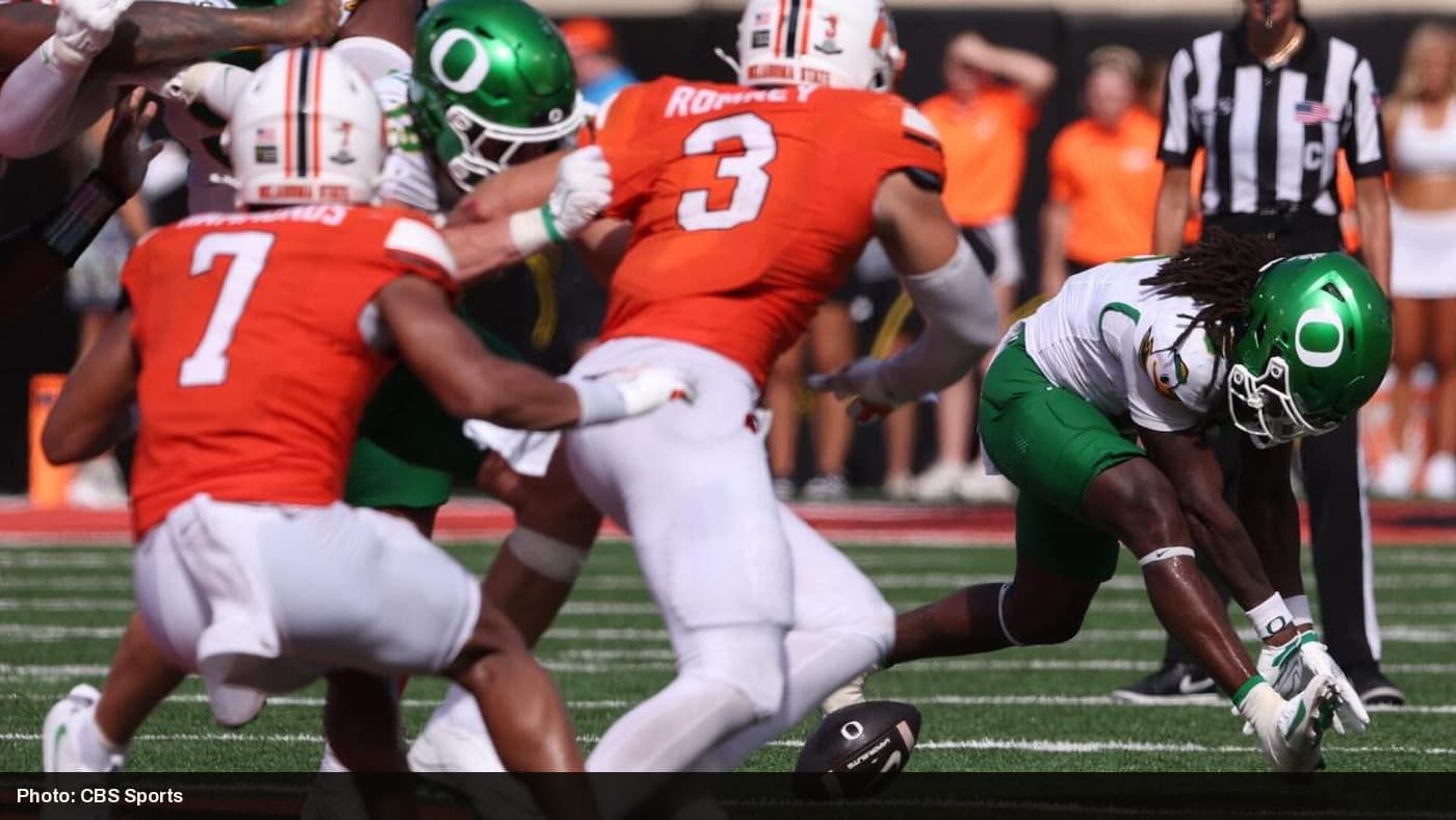 Oklahoma State defenders force an Oregon fumble during their 39-31 upset win.