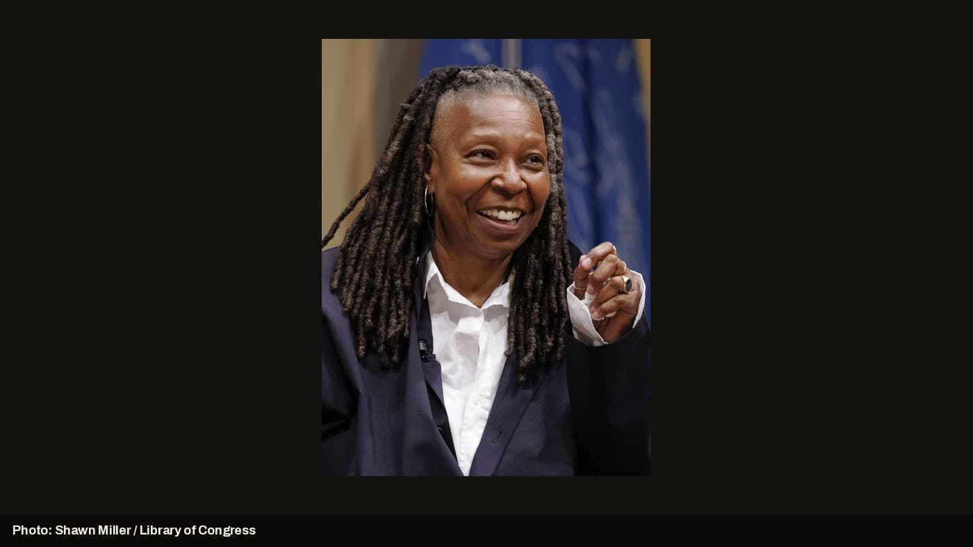 Whoopi Goldberg speaking at a public event.