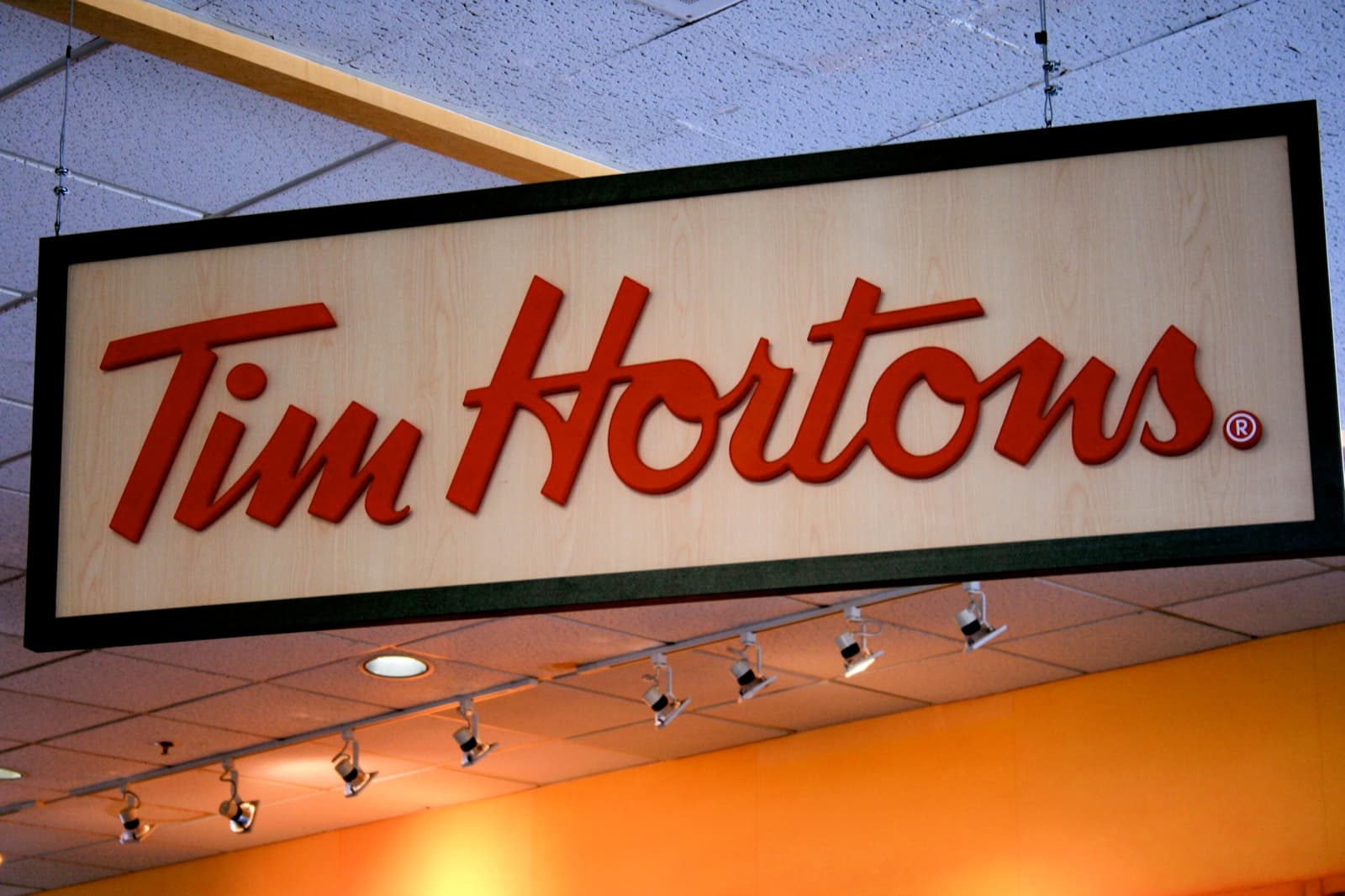A Tim Hortons store sign hanging inside a restaurant (file photo, not the specific Langley location)