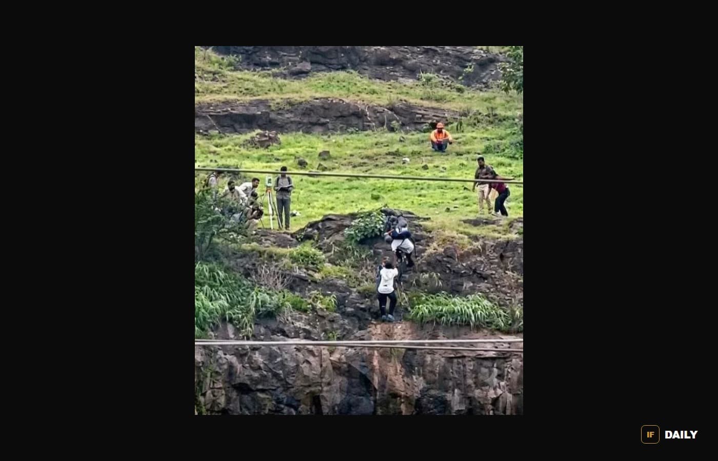 Police, fire personnel and villagers gather on the hillside during the hours-long attempt to talk Kunal down, in a photo that has circulated widely in Indian news coverage