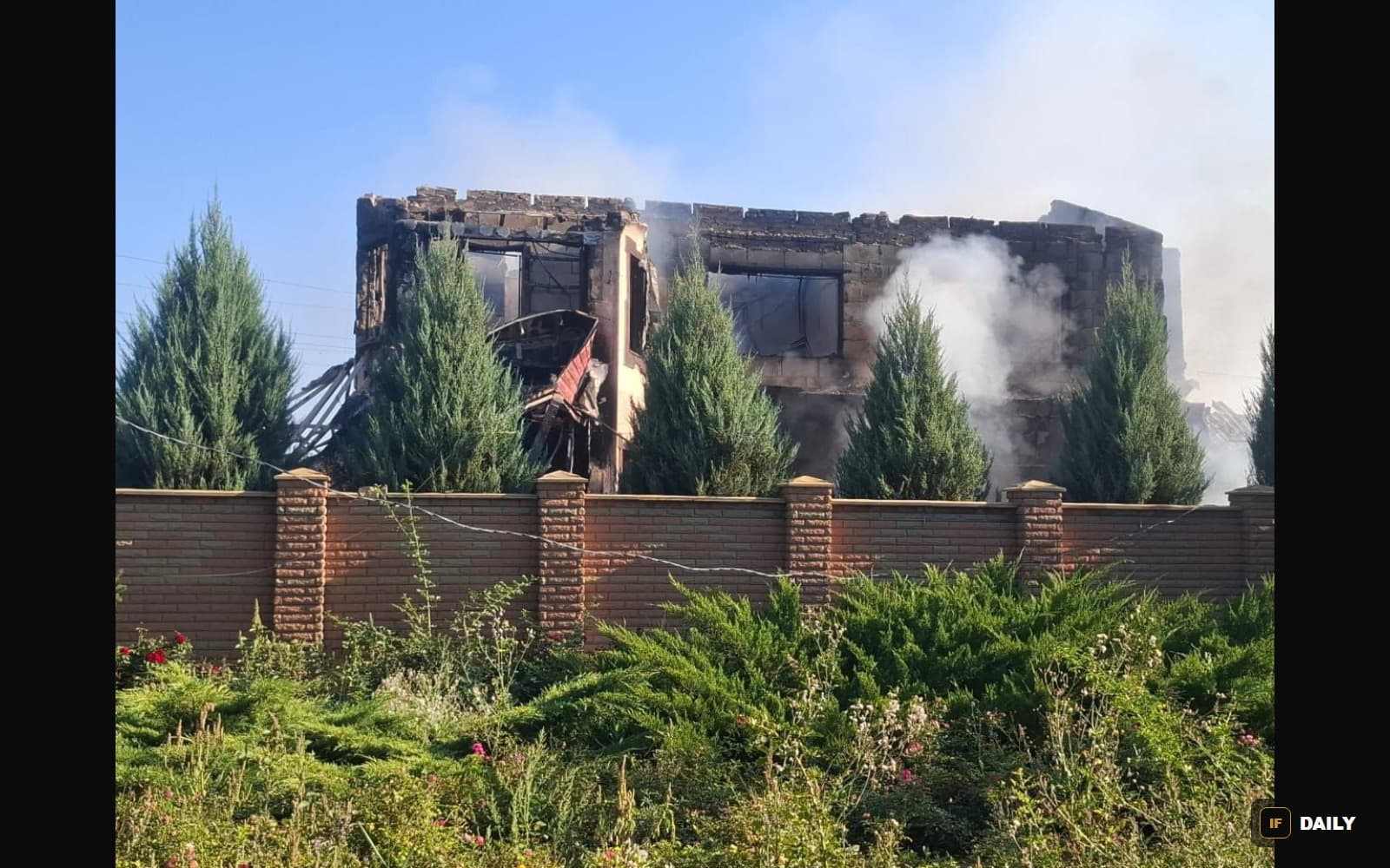 A residential building damaged by a Russian strike in Ukraine, still smoking, photographed the morning of the attack