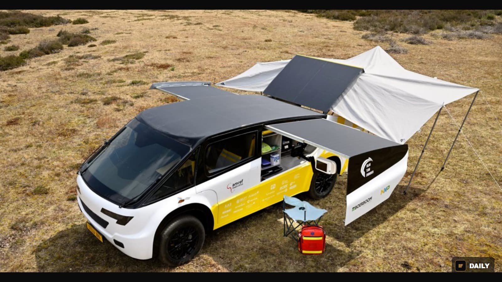 The solar-powered ambulance Stella Juva with its solar panels and awning deployed, medical kit visible beside it