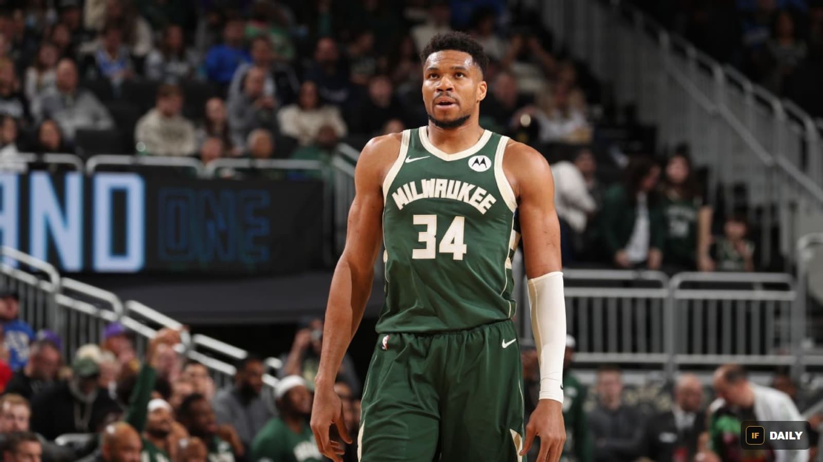 Giannis Antetokounmpo wearing a Milwaukee Bucks jersey number 34, standing on the court