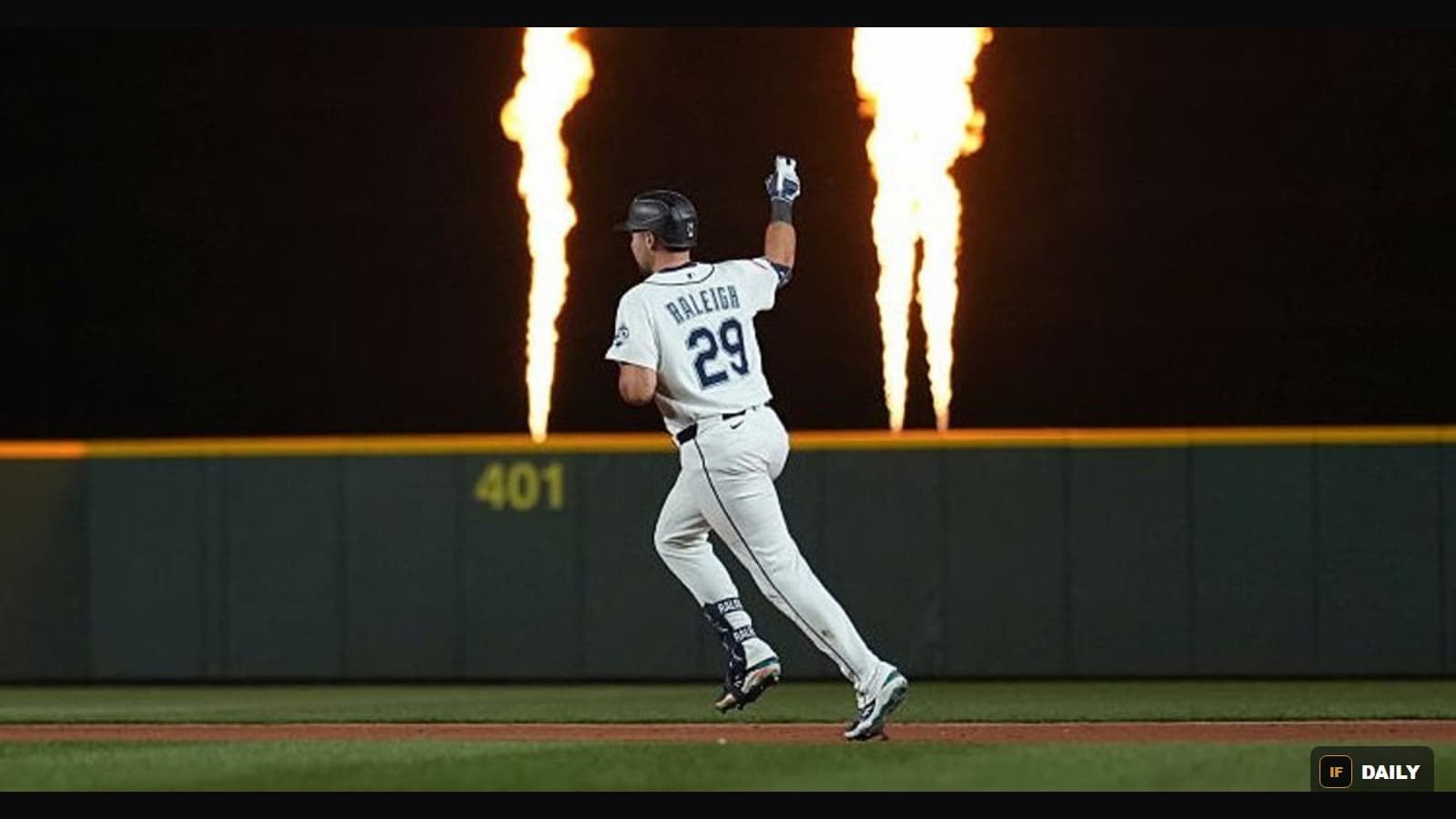 Cal Raleigh, wearing number 29, running the bases with home run fireworks blazing behind him at T-Mobile Park