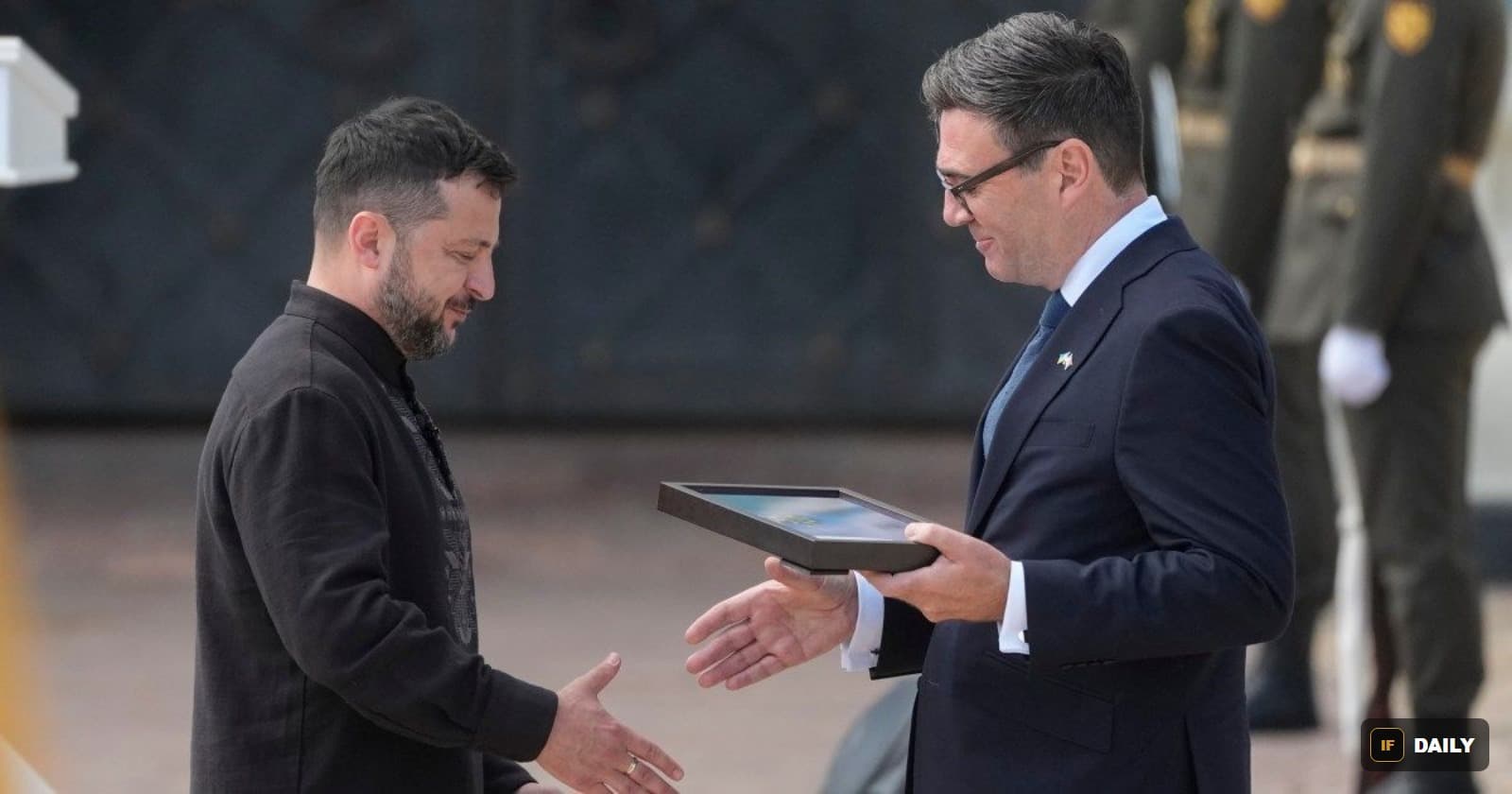 Ukrainian President Volodymyr Zelenskyy exchanging a framed gift with UK Prime Minister Andy Burnham in Kyiv