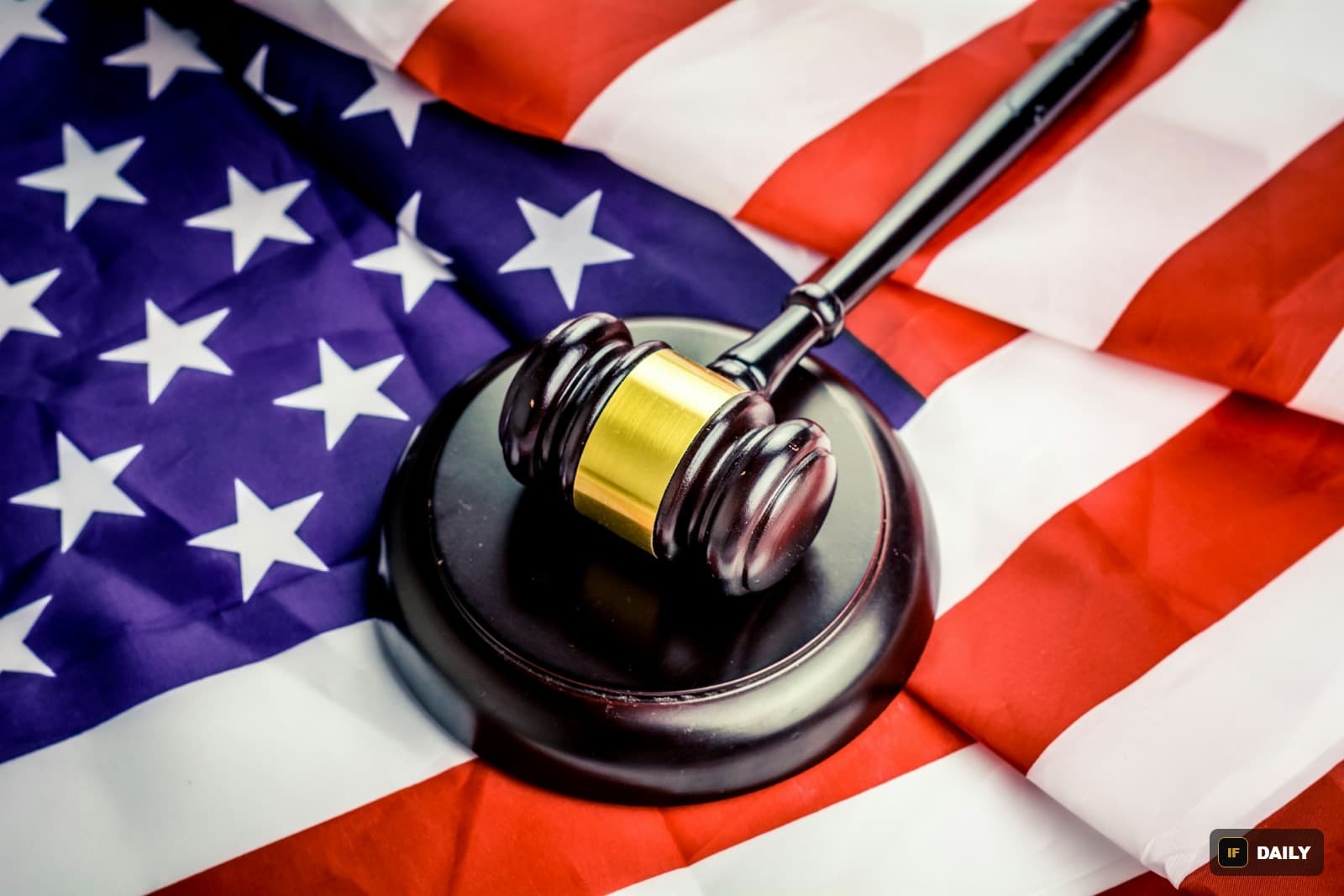A judge''s gavel resting on an American flag