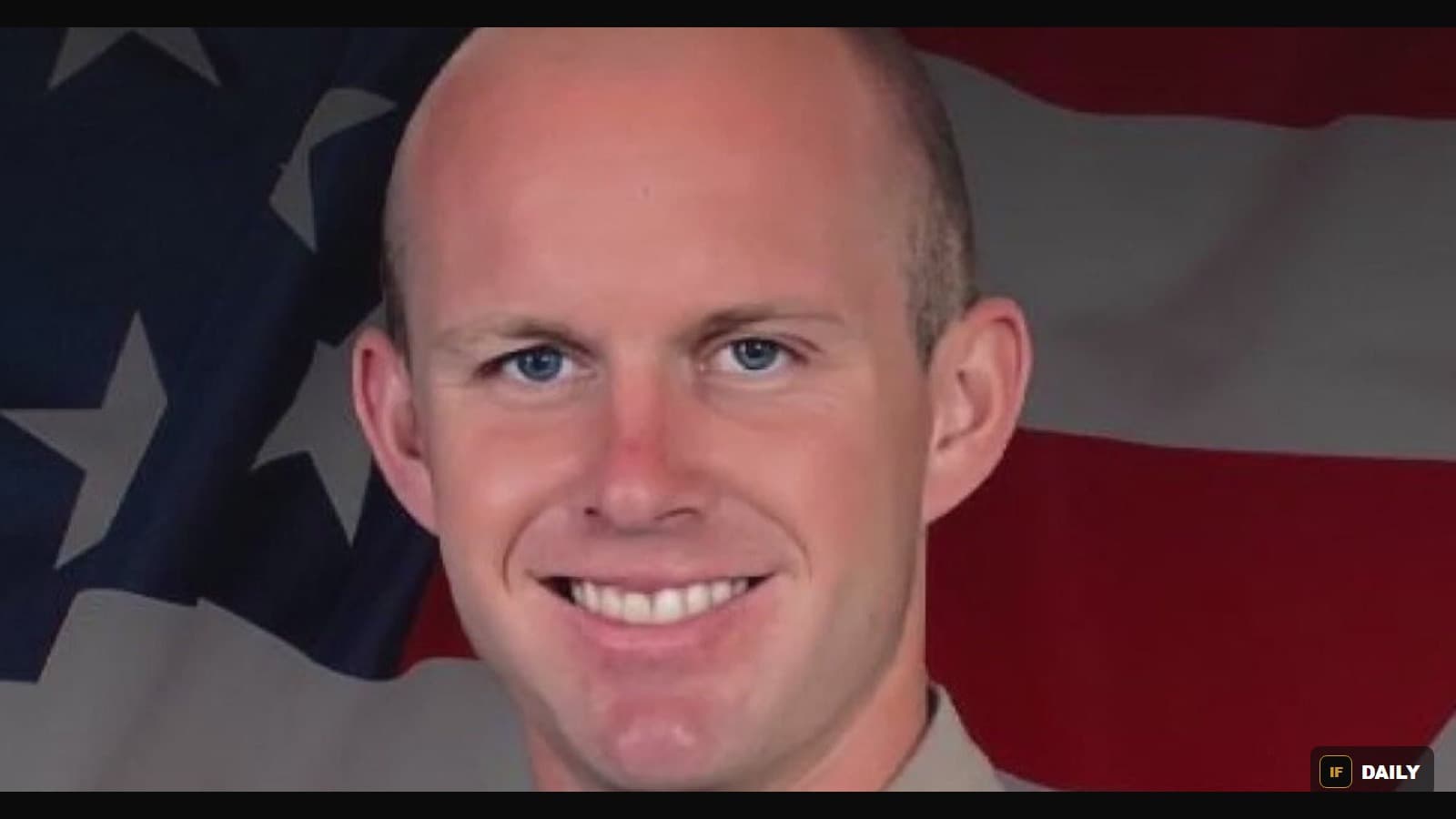 Official portrait of Los Angeles County Sheriff's Deputy Ryan Clinkunbroomer in uniform in front of an American flag