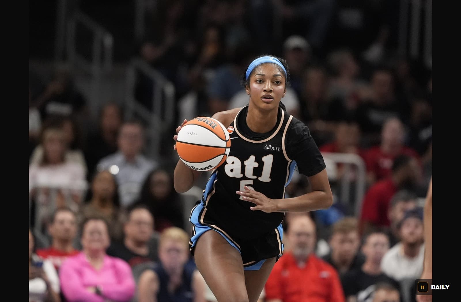 Angel Reese dribbling the ball in an Atlanta Dream jersey during a WNBA game
