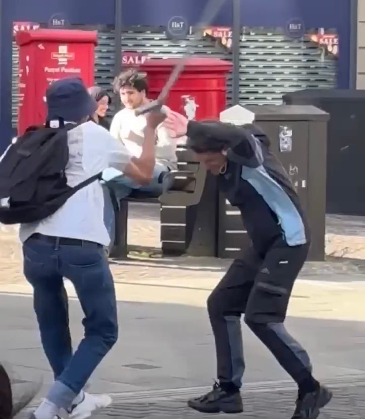 Screenshot from a viral video showing a scuffle between two men in Bradford city centre