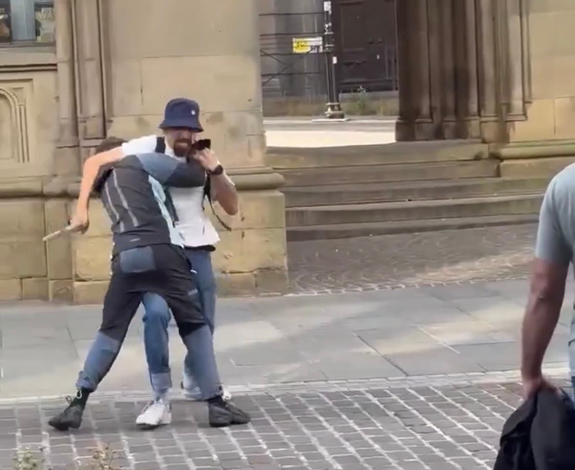 Screenshot from a viral video showing a scuffle between two men in Bradford city centre