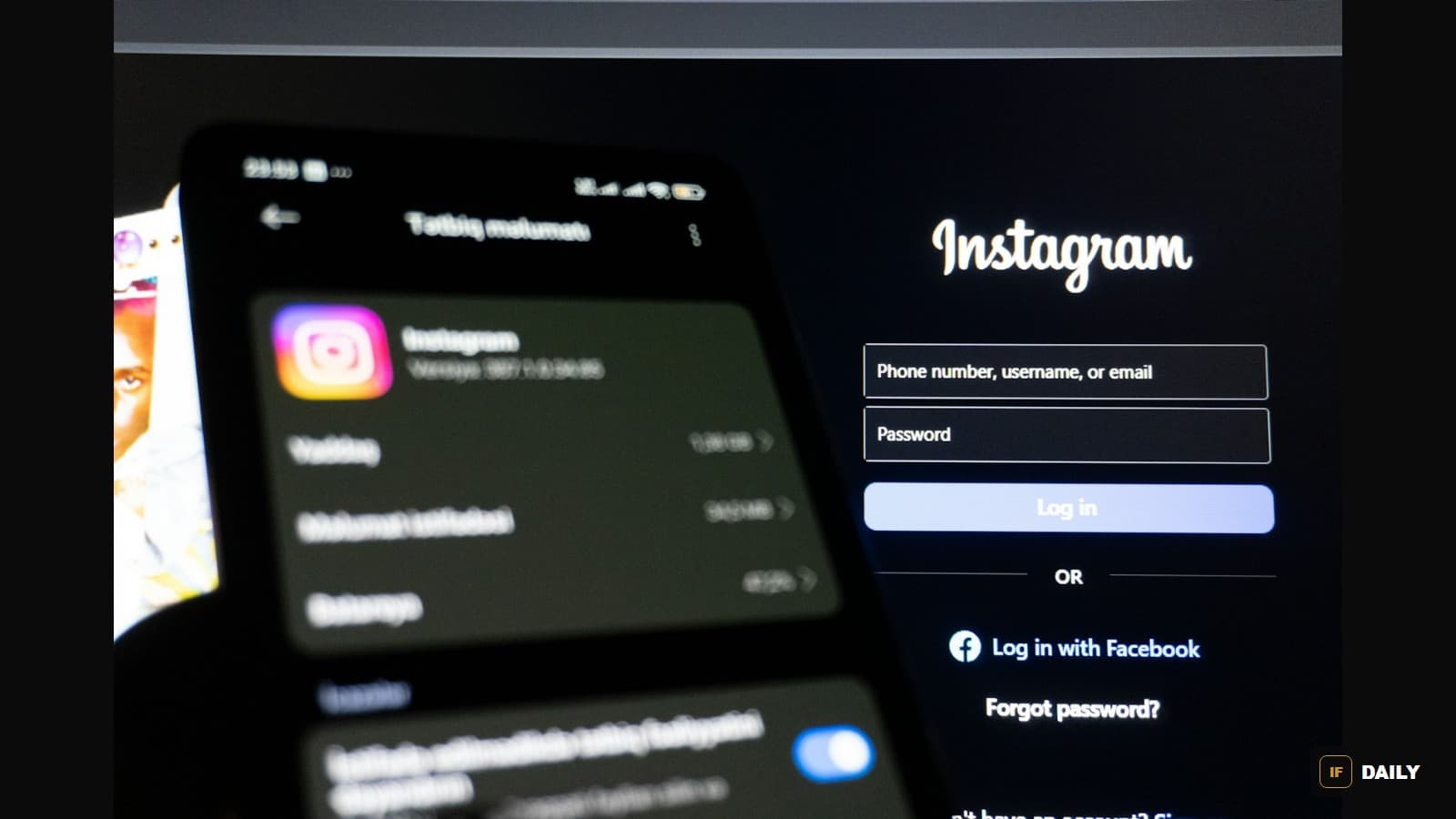 An Instagram login screen glowing on a smartphone held up in a dark room