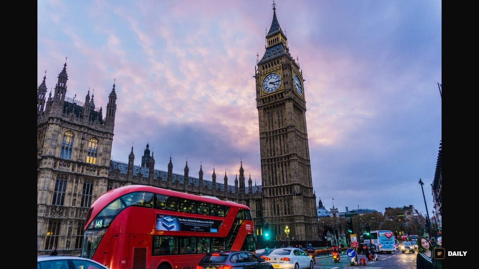 Big Ben and the Houses of Parliament at dusk, with a red double-decker bus passing in the foreground