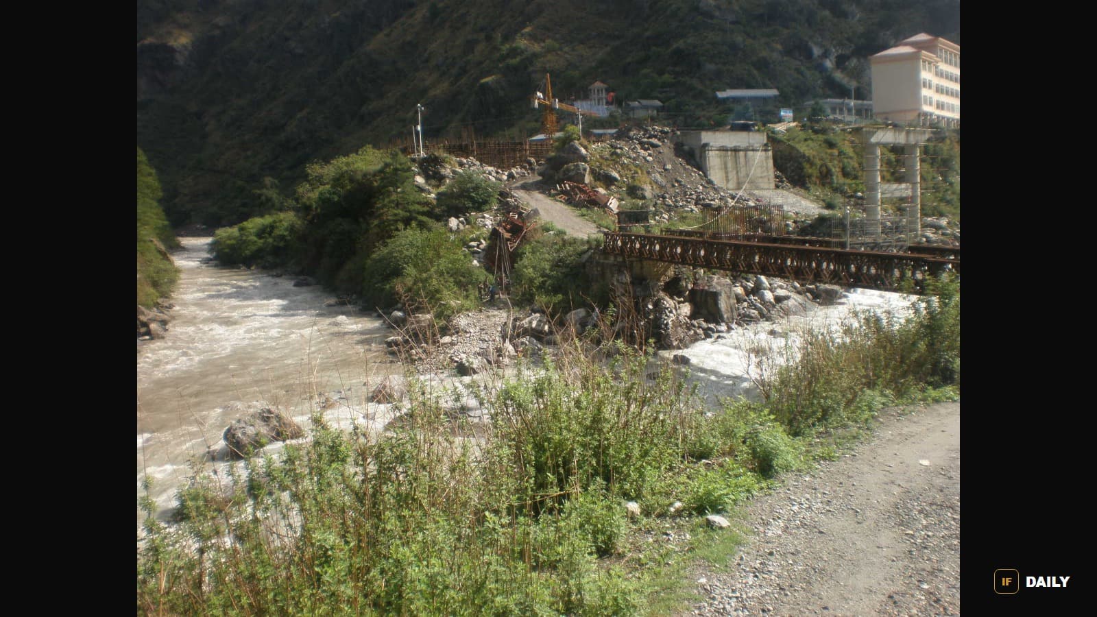 The fast-flowing Trishuli River in Rasuwa district, Nepal, near a bridge and hillside construction