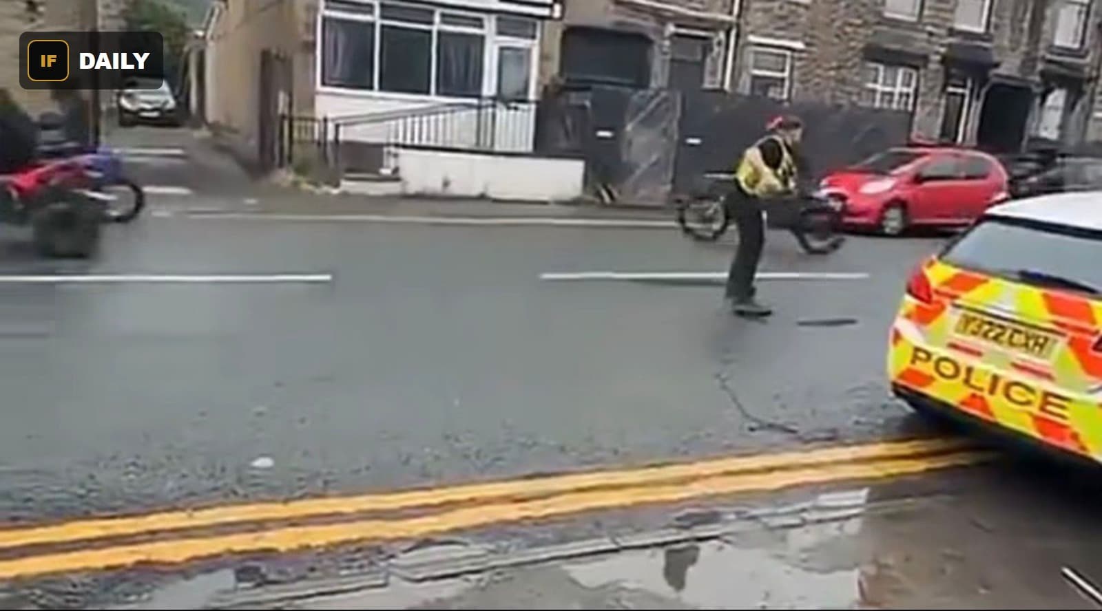 A police officer on foot near a bicycle on the street, with the quad bike visible further away